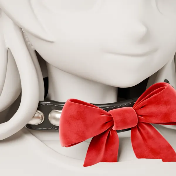 A studded collar with a red velvet bow on a plain white display figure.