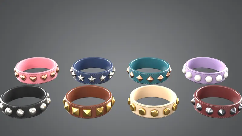 Eight studded collars on grey: pink with hearts, navy with stars, teal, lavender, black, brown, cream and burgundy.