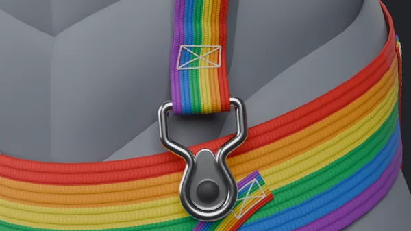 Close-up of a silver clip joining a rainbow strap to a wide rainbow waist belt.